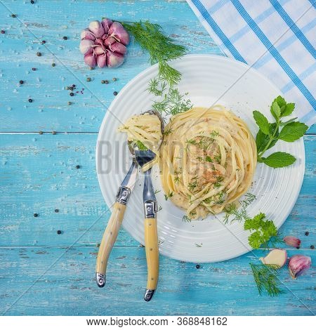 Beautifully-servered, Turquoise Wooden Table, On Which There Is A Plate With Italian Pasta With Chic