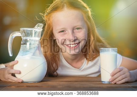 Red-haired Girl, With Green Eyes, Smiling, Showing Strong White Teeth, Against A Sunny Morning.fresh