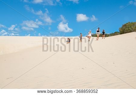 Fraser Island Australia - March 13 2014; Tourists Walking Through Sand Of Lake Wabby Sand Blow