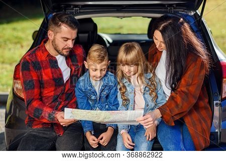Close Up Of Joyful Pleasant Family Which Gethering On Their Vacation With Teen Children And Using Ro