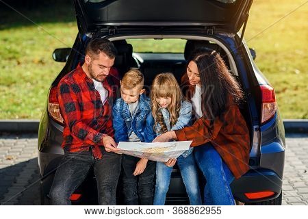 Close Up Of Joyful Pleasant Family Which Gethering On Their Vacation With Teen Children And Using Ro