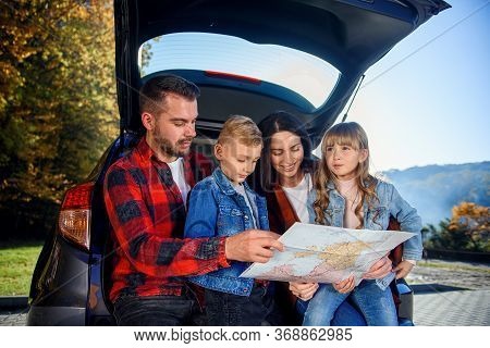 Close Up Of Joyful Pleasant Family Which Gethering On Their Vacation With Teen Children And Using Ro