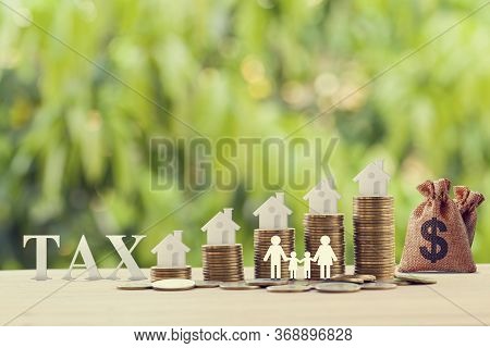 Family Members, House, Dollar Money Bags On Rows Of Rising Coins. Concept Family Tax Benefit, Reside