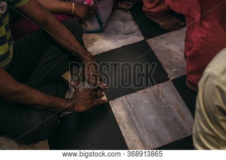 People Sit And Pray Or Meditate On The Floor In Asia