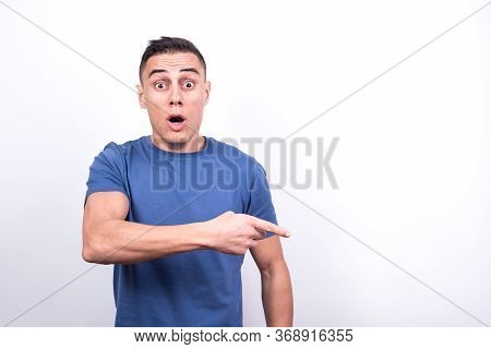 Surprised Man Pointing To Copy Space