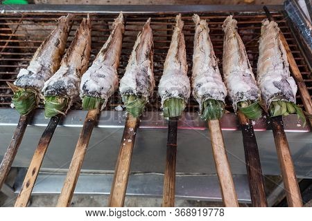 Striped Snakehead Fish Grilled With Salt. Pomegranate Fish With Salt And Then Burned For Sales In Th