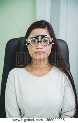 Consultation With An Ophthalmologist. Young Asian Woman In Clinic Office.