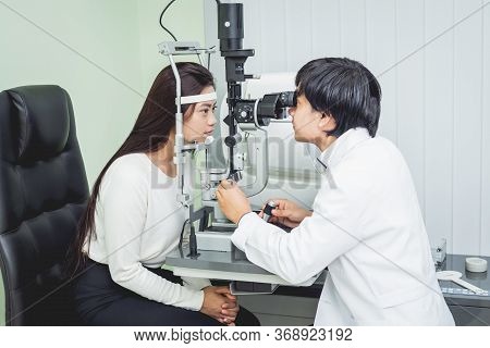 Consultation With An Ophthalmologist. Young Asian Woman And Doctor