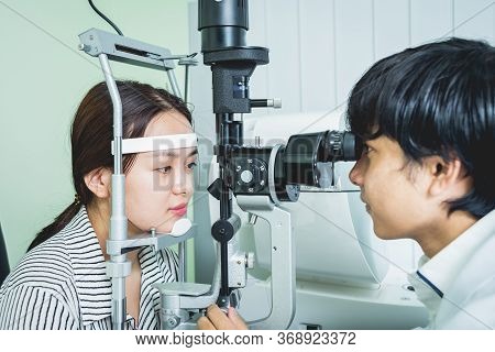 Consultation With An Ophthalmologist. Young Asian Woman And Doctor