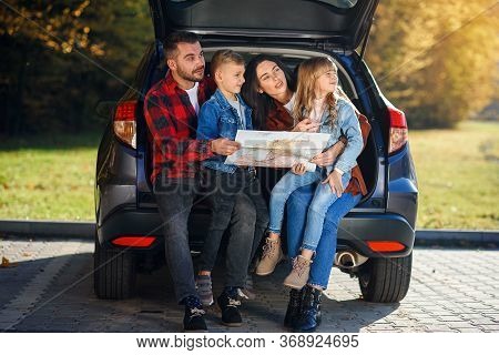 Close Up Of Joyful Pleasant Family Which Gethering On Their Vacation With Teen Children And Using Ro