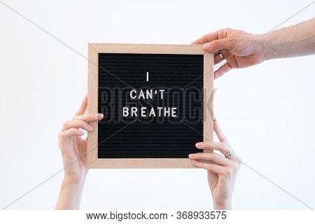 Hands Holding A Felt Letter-board With Word Black Lives Matter And I Cantt Breathe