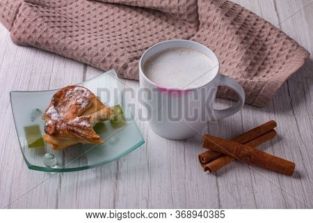 A Cup Of Coffee With A Lipstick Print On It. A Bitten-off Loaf On A Plate.