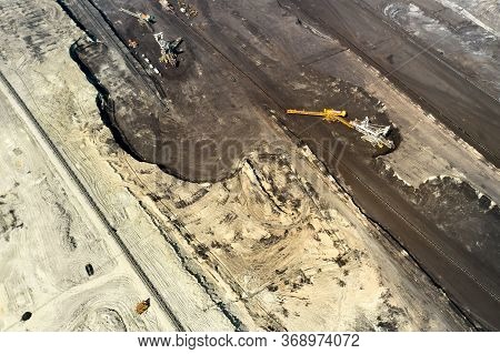 Aerial Shoot Of Quarry With Heavy Bucket Wheel Excavators Mining A Coal. Heavy Industry Concept.