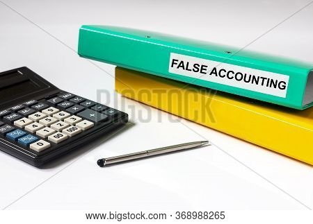 False Accounting Text Words Inscription On Mint Folder With Folder Calculator Pen On Glossy White Ba