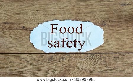 Words 'food Safety' On The Piece Of Paper. Beautiful Wooden Background.
