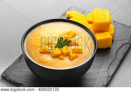 Pumpkin Cream Soup Mashed Potatoes On A Gray Background. Vegan Curried Pumpkin Lentil Soup Puree In 