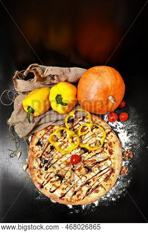 Delicious Italian Pizza With Mushrooms And Melted Cheese On A Black Table Surrounded By Cherry Tomat