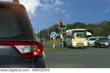 Rear Side Of Car Driving On The Asphalt Road. Stop And Open Turn On Light Brake By Traffic Light Sig