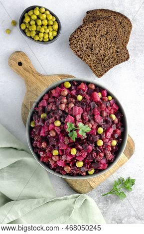Russian Salad Top View. Vinaigrette Salad With Rye Bread On A Gray Background. Beetroot Salad.
