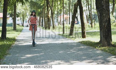 A Girl Rolls Around On City Tiles In The Park.