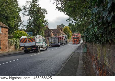 Aldermaston, Uk - October 27, 2021:  Three Lorries Being Driven Through The Pretty Village Of Alderm