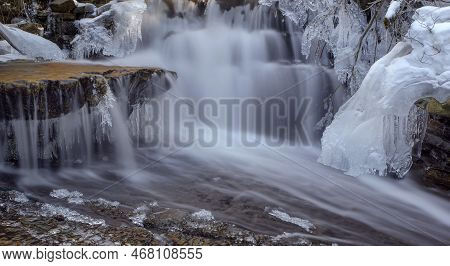 Frozen Waterfall. Mountain Water Cascades Covered With Ice