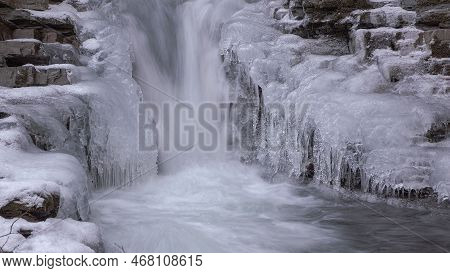 Frozen Waterfall. Mountain Water Cascades Covered With Ice