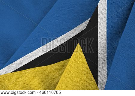 Saint Lucia Flag With Big Folds Waving Close Up Under The Studio Light Indoors. The Official Symbols