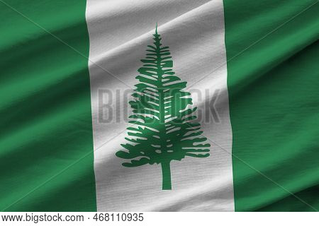 Norfolk Island Flag With Big Folds Waving Close Up Under The Studio Light Indoors. The Official Symb