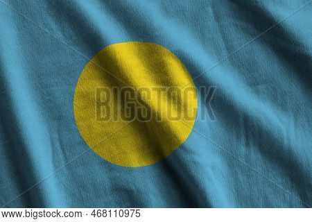 Palau Flag With Big Folds Waving Close Up Under The Studio Light Indoors. The Official Symbols And C