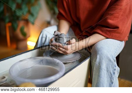 Close Up Of Female Shaping Walls Of Vase On Rotating Pottery Wheel While Working In Studio, Selectiv