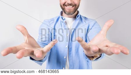Grabbing Hands With Grab Gesture In Studio. Photo Of Grabbing Hands With Grab Gesture.