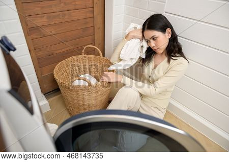 Exhausted  Asian Young Woman With Dirty Clothes , Doing Laundry In Home