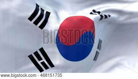 Close-up View Of The South Korea National Flag Waving. The Flag Is A White Field With A Red And Blue