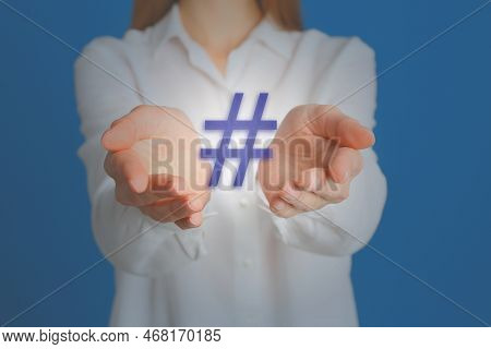 Hashtag Concept. Woman Holding Sign On Light Blue Background, Closeup