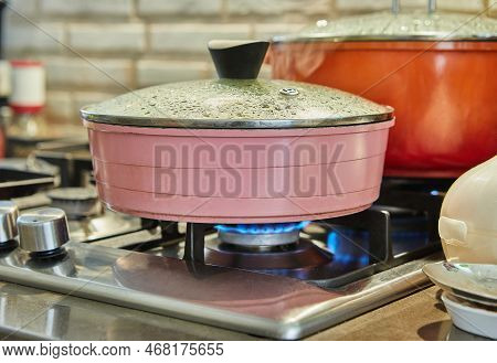 Cooking Food In Frying Pan And Pot On Gas Stove In The Kitchen. Home Cooking Concept