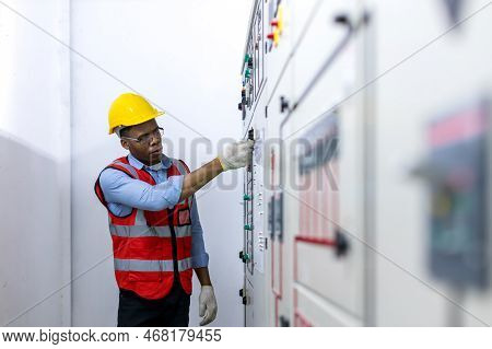 Electrical Engineer Working In Control Room. Electrical Engineer Man Checking Power Distribution Cab