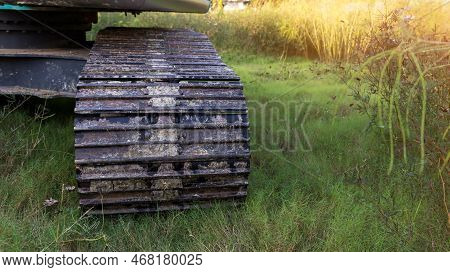 Excavator Tracks. Old Iron Caterpillars Of The Bulldozer Of The Tractor On The Road. Bulldozer Cater