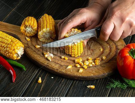 Chef Cuts Corn With A Knife. Maize Is An Excellent Dietary Breakfast Or Lunch With Vegetables. Worki
