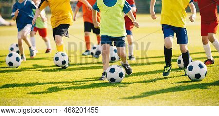 Choldren Football Team On Training. Group Of School Kids Running With Soccer Balls On Grass Venue