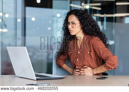 Sick Business Woman Working Inside Office Using Laptop While Sitting At Table, Hispanic Woman Has Se