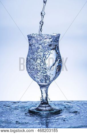 The Image Of Pouring Drinking Water, Into A Broken Glass, That Makes One Feel Refreshed On Blurred W