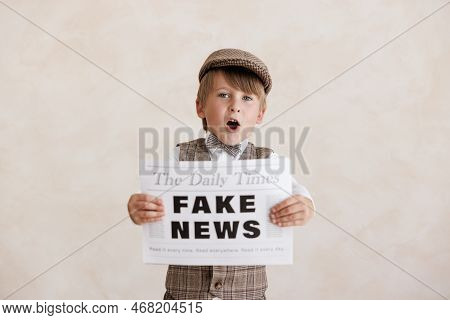 Newsboy Shouting Against Grunge Wall Background. Boy Selling Fake News