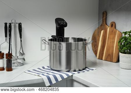 Pot With Sous Vide Cooker In Kitchen. Thermal Immersion Circulator