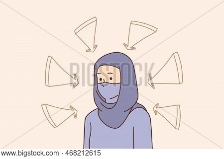 Unhappy Young Muslim Woman In Hijab With Arrows Pointing At Her. Stressed Arabic Female In Tradition