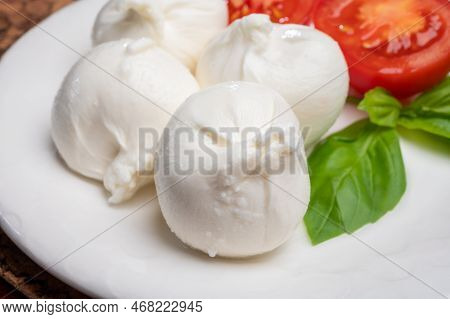 Eating Of Fresh Handmade Soft Italian Cheese From Puglia, White Balls Of Burrata Or Burratina Cheese