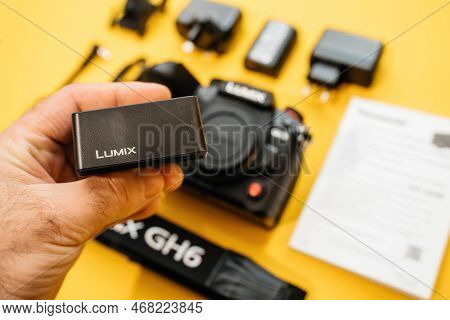 Paris, France - Nov 20, 2022: Male Hand Holding Lumix Vsk0815l Charger For Rechargable Li-ion Batter