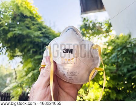 Paris, France - Mar 3, 2022: Pov Male Hand Holding Used 3m Ffp1 Respiratory Mask - Unfocused Blur Ba