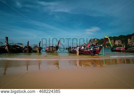 Krabi, Thailand: Jan 1st, 2019 - Aonang Beach With Tourists And Long Tail Boats. A Famous Travel Des