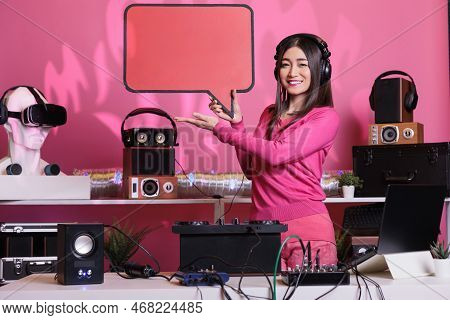 Smiling Performer Advertising Red Carton Speech Bubble In Studio, Showing Isolated Text Message Card
